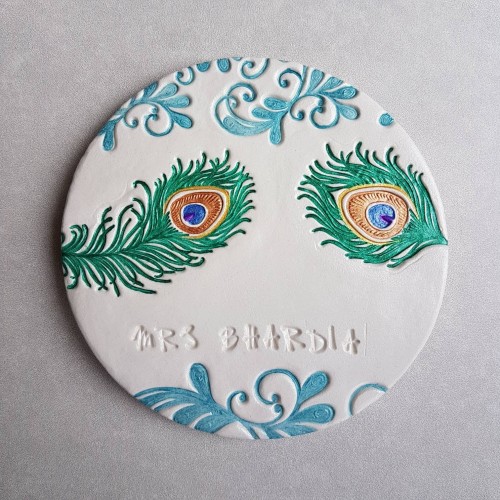 Personalised clay coaster with peacock feather design