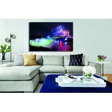 Niagara Falls lit at night by colorful lights with fireworks Printed Canvas